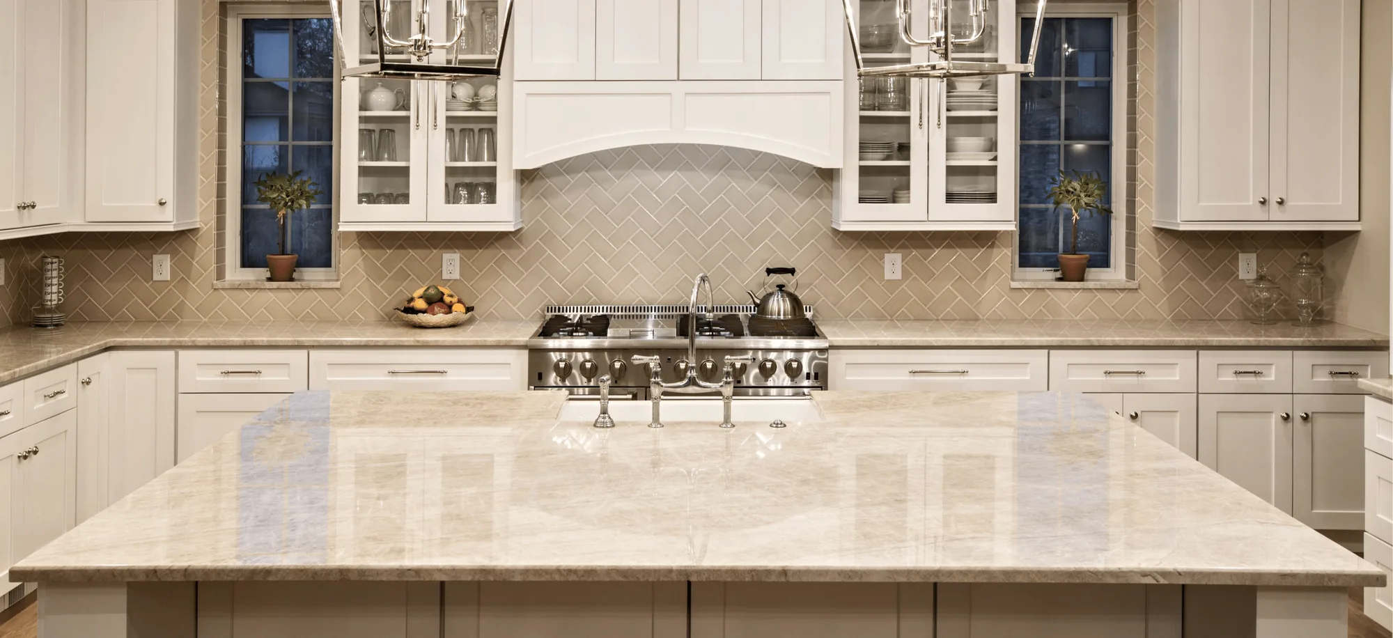 Taj Mahal Quartzite Kitchen Countertops and Island with Cream Subway Tile Backsplash Natural Stone Countertops