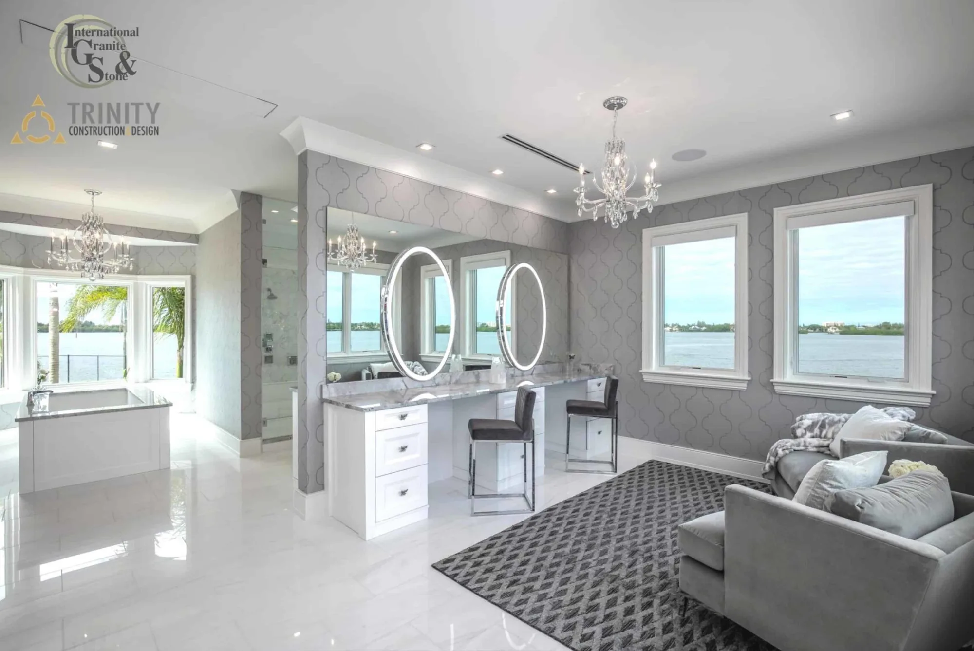 Super White Quartzite Calcatta Quartzite Marble Countertops Bathroom Countertops Bathtub Surround Countertop International Guild of Surfaces Trinity Construction and Design Ryan Gamma Photographer Double Bathroom Vanity White Cabinets White Tile Gray Tile White and Gray Bathroom Make Up Table Make-Up Vanity Tub Surround