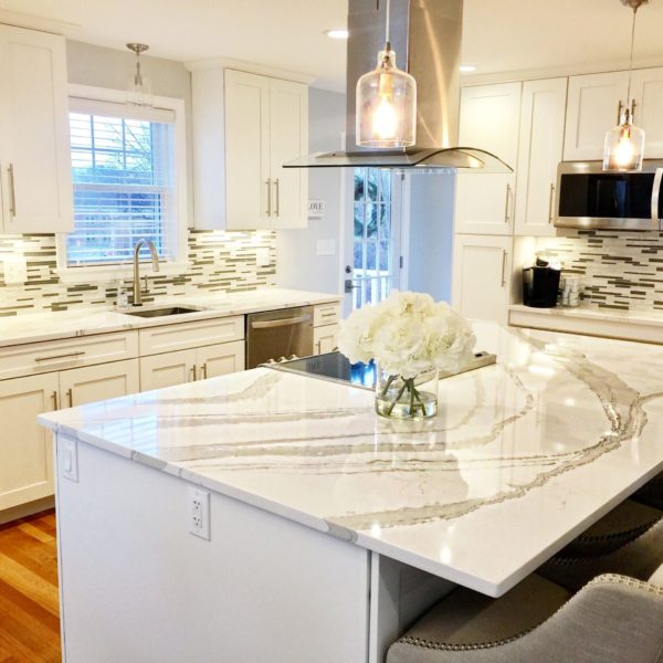 Brittanicca Warm Cambria Quartz Kitchen Countertops with White Cabinets, Stainless Steel, and Bar Stools