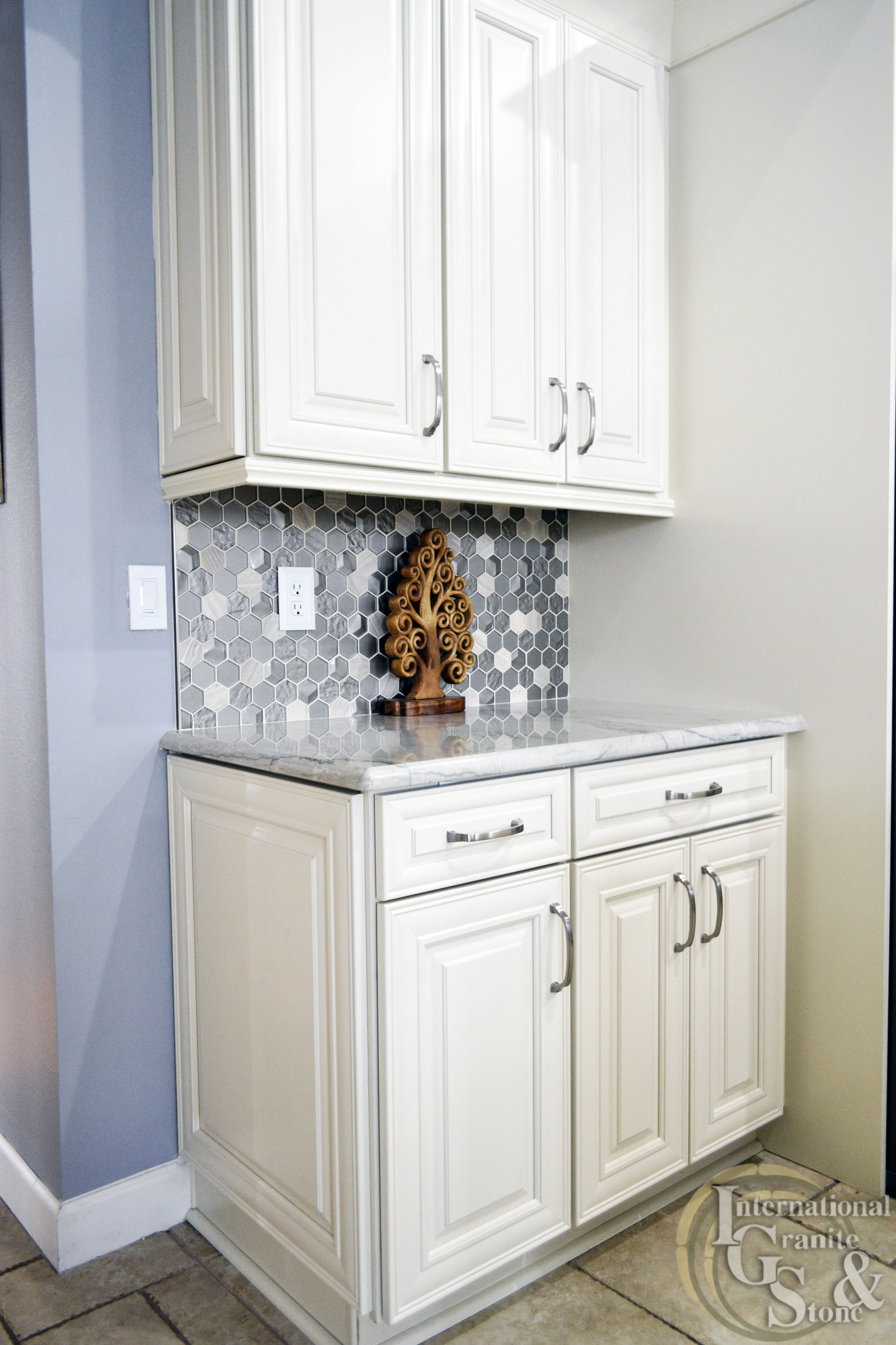 Quartzite Countertops with White Cabinets and Tile Backsplash