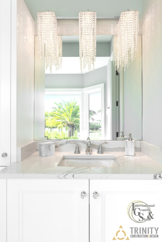 Cambria Quartz Bathroom Vanity with White Cabinets and Luxury Lighting
