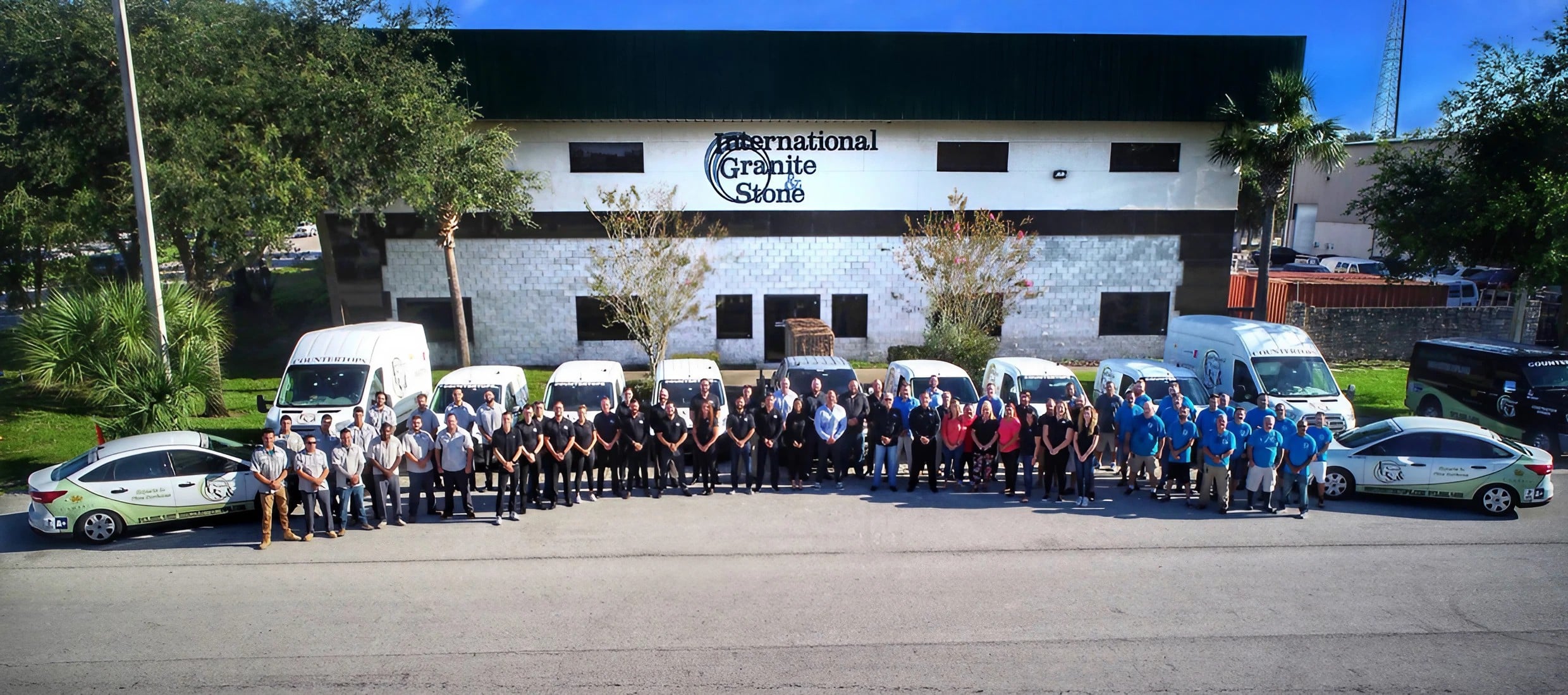 Image featuring IGS Countertops' team of skilled installers and experts proudly standing in front of the IGS Countertops fabrication shop, showcasing the heart of where craftsmanship meets expertise.