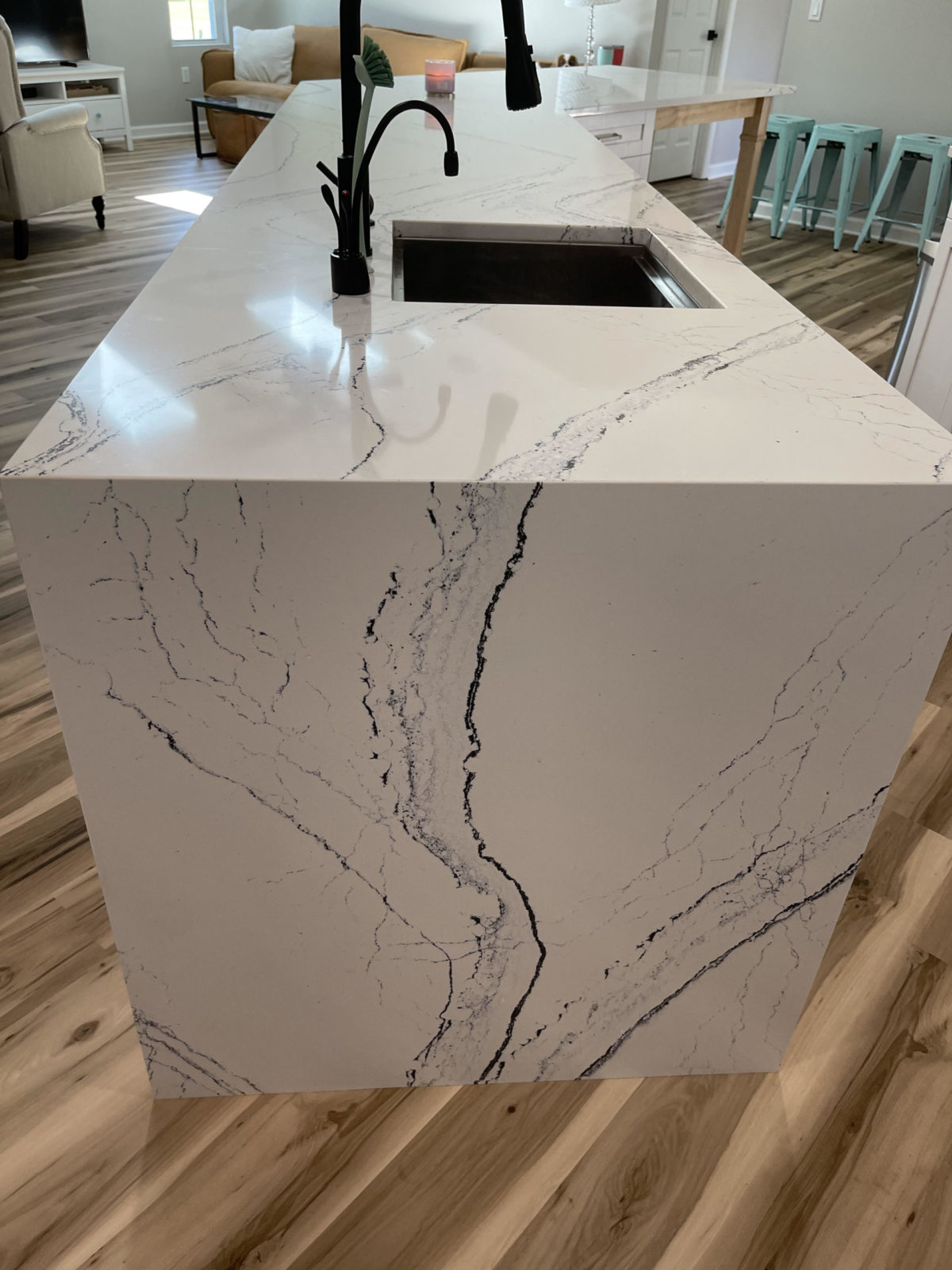 Portrush Cambria Quartz Kitchen Countertops with White Cabinets and Waterfall Panel with Vein Matching